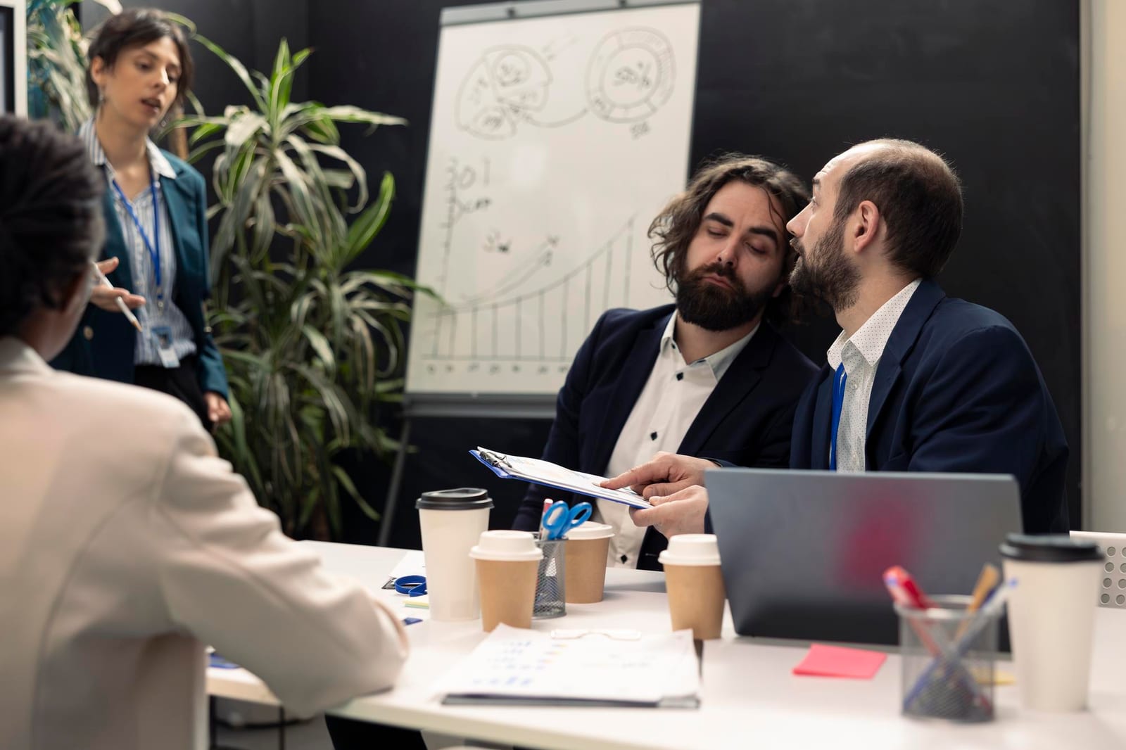 Colleghi che discutono gli aggiornamenti di un progetto in sala riunioni